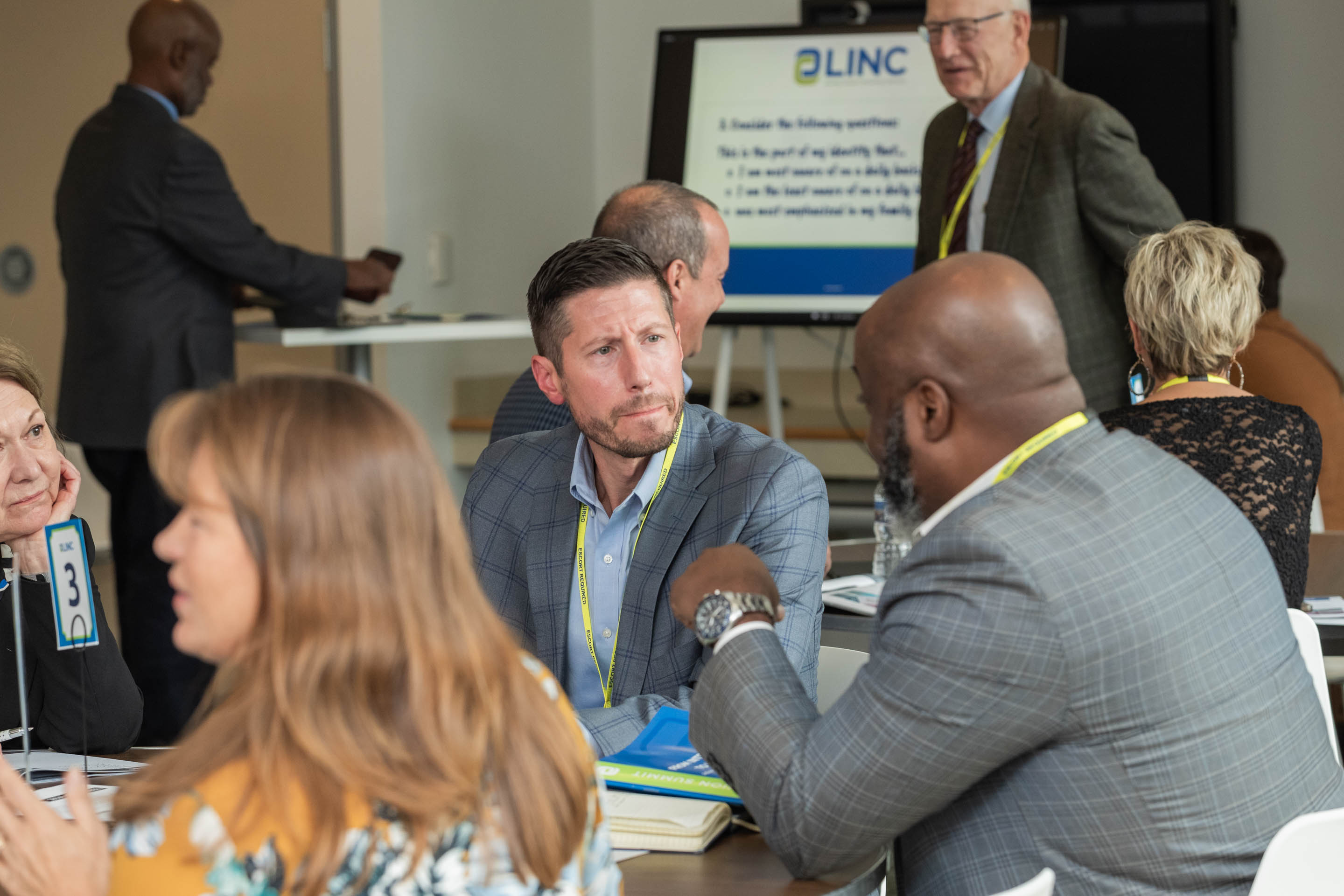 Business professionals at table talking.