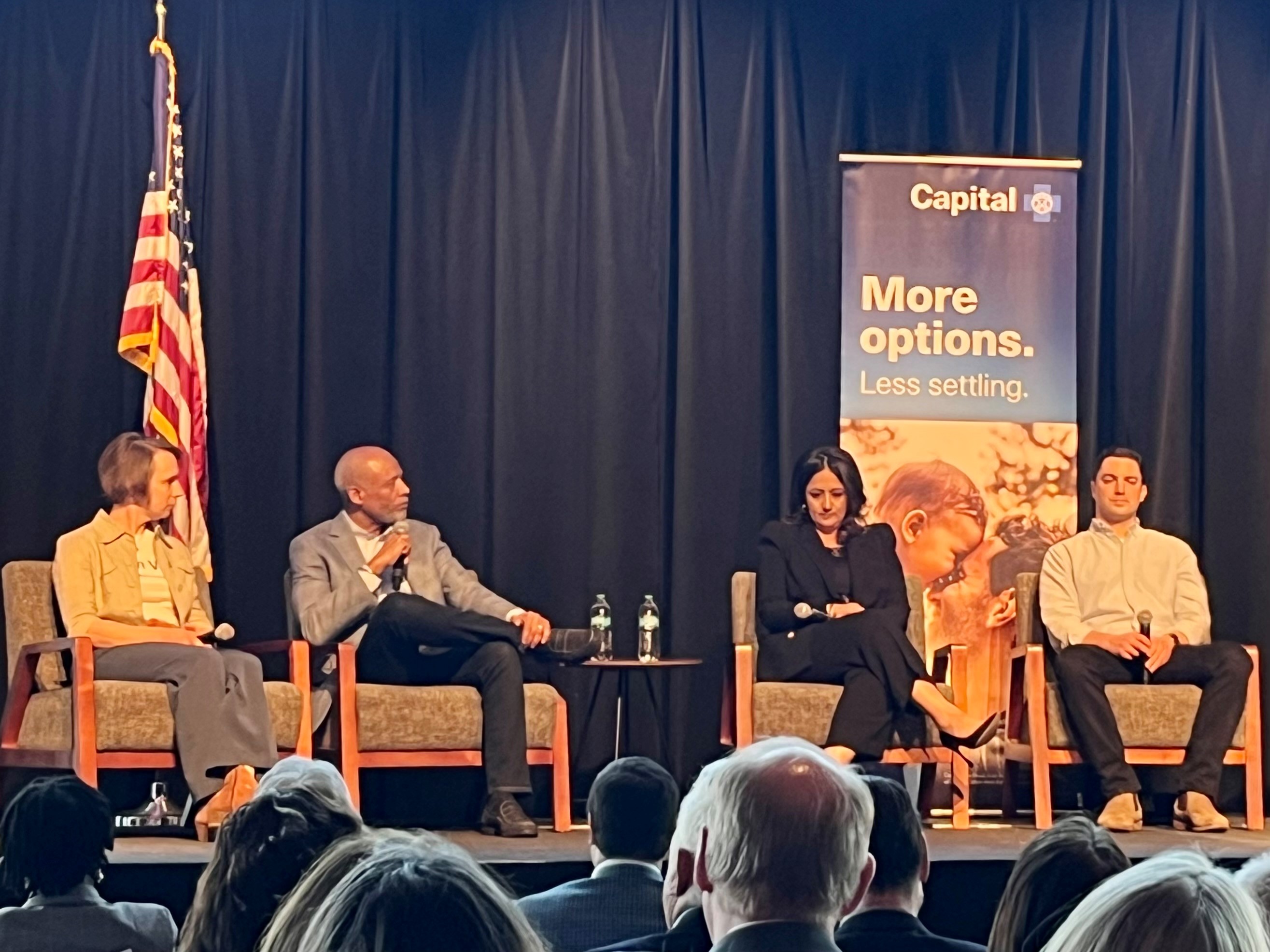 Talent panel sitting on chairs on stage at the Annual Meeting